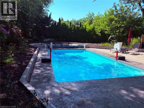 In-ground swimming pool with stamped concrete decking - 23 Bentley Place, Hamilton, ON - Outdoor With In Ground Pool With Backyard