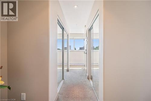 Hallway with neutral wall tones, recessed lighting, and mirrored closet doors - 36 Hayhurst Road Unit# 329, Brantford, ON - Indoor Photo Showing Other Room