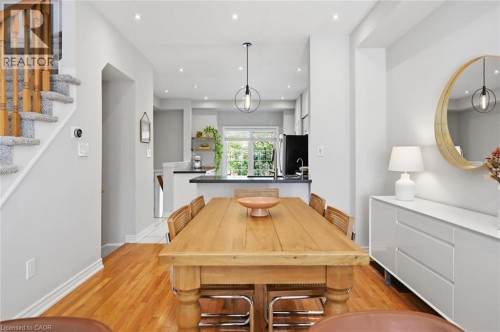 Open-concept living space featuring wood-finish flooring, recessed lighting, and a modern pendant light fixture - 678 Rowley Common, Burlington, ON - Indoor Photo Showing Dining Room