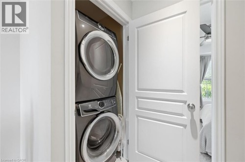Dedicated laundry closet featuring a stacked washer and dryer, providing functional utility - 678 Rowley Common, Burlington, ON - Indoor Photo Showing Laundry Room