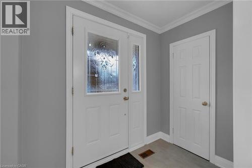 Entryway featuring a white door with decorative glass, a complementary sidelight, and a six-panel interior door - 197 Troy Street, Mississauga, ON - Indoor Photo Showing Other Room