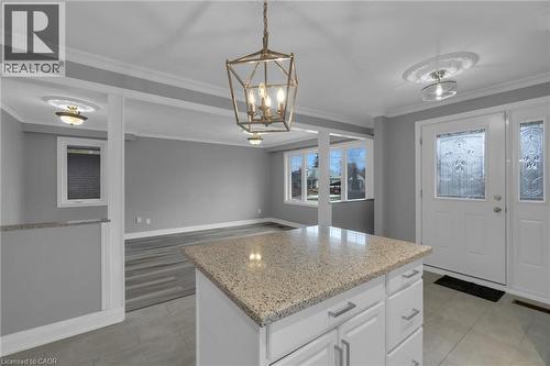 Kitchen island featuring a speckled countertop and white cabinetry with brushed nickel hardware - 197 Troy Street, Mississauga, ON - Indoor