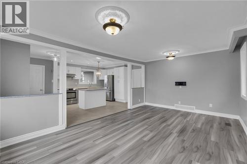 Spacious room featuring wood-finish flooring, crown molding, and recessed lighting - 197 Troy Street, Mississauga, ON - Indoor
