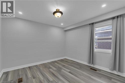Room featuring wood-finish flooring, recessed lighting, and a centered ceiling fixture - 197 Troy Street, Mississauga, ON - Indoor Photo Showing Other Room