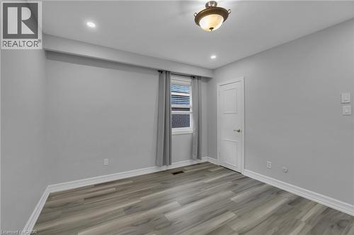 Room featuring wood-finish flooring, recessed lighting, and a window with blinds - 197 Troy Street, Mississauga, ON - Indoor Photo Showing Other Room