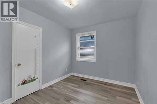 Room with wood-finish flooring, light blue wall paint, and white trim - 197 Troy Street, Mississauga, ON - Indoor Photo Showing Other Room