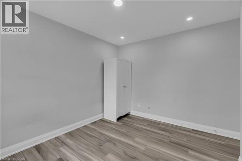 Room featuring light gray walls, recessed lighting, wood-finish flooring, and white baseboards - 197 Troy Street, Mississauga, ON - Indoor Photo Showing Other Room