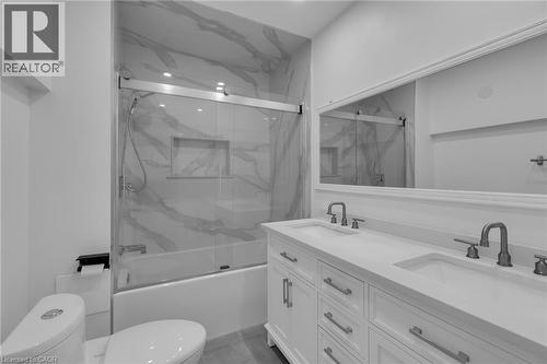 Bathroom featuring a dual vanity with undermount sinks, white cabinetry, and brushed nickel hardware - 197 Troy Street, Mississauga, ON - Indoor Photo Showing Bathroom