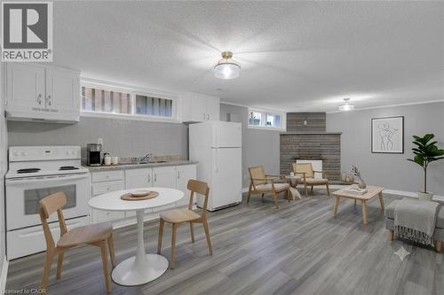 Open-concept living space featuring wood-finish flooring, a stone fireplace, and recessed lighting - 197 Troy Street, Mississauga, ON - Indoor