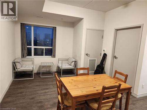 Dining room featuring dark wood finished floors and baseboards - 269 Sunview Street Unit# 607, Waterloo, ON - Indoor