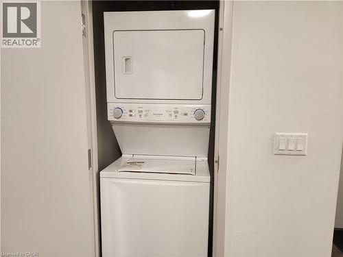 Clothes washing area with laundry area and stacked washer / drying machine - 269 Sunview Street Unit# 607, Waterloo, ON - Indoor Photo Showing Laundry Room