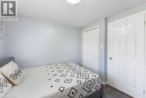 Bedroom featuring gray walls, wood-finish flooring, and a textured ceiling - 33 Remple Court, Cambridge, ON - Indoor Photo Showing Bedroom