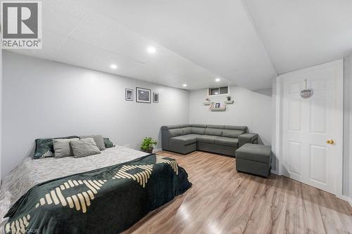 Spacious room featuring wood-finish flooring, recessed lighting, and light gray walls - 33 Remple Court, Cambridge, ON - Indoor