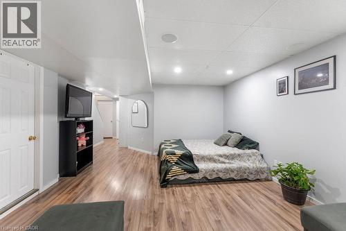 Finished lower level featuring wood-finish flooring, recessed lighting, and a drop ceiling - 33 Remple Court, Cambridge, ON - Indoor