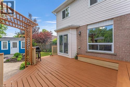 Expansive wood deck with a built-in bench, offering direct access to the backyard through a sliding glass door - 33 Remple Court, Cambridge, ON - Outdoor With Deck Patio Veranda With Exterior