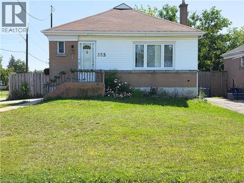 Brick and siding exterior with a shingled roof, featuring a front entry door with decorative glass - 353 East 21St Street, Hamilton, ON - Outdoor