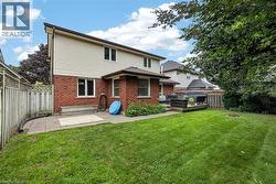 Expansive green lawn with a wooden fence boundary - 