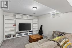 Built-in white shelving and media console with gray and white cabinetry - 