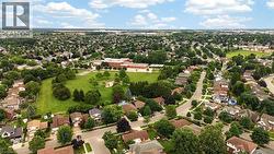 Residential neighborhood with mature trees and a large central green space - 