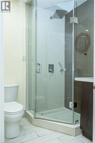 Glass-enclosed shower with a rainfall showerhead, linear drain, and tiled walls - 41 Paradise Road S, Hamilton, ON - Indoor Photo Showing Bathroom
