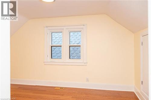 Hardwood flooring, painted walls, white trim, double-hung window, and a flush mount light fixture - 41 Paradise Road S, Hamilton, ON - Indoor Photo Showing Other Room