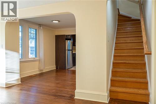 Archway entry to a room featuring wood-finish flooring, white window trim, and a flush-mount ceiling light - 41 Paradise Road S, Hamilton, ON - Indoor Photo Showing Other Room