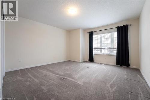 Carpeted empty room with a textured ceiling and baseboards - 13 Steven Drive, Thorold, ON - Indoor Photo Showing Other Room