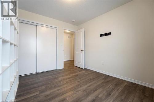 Unfurnished bedroom with a closet, dark wood finished floors, and baseboards - 13 Steven Drive, Thorold, ON - Indoor Photo Showing Other Room