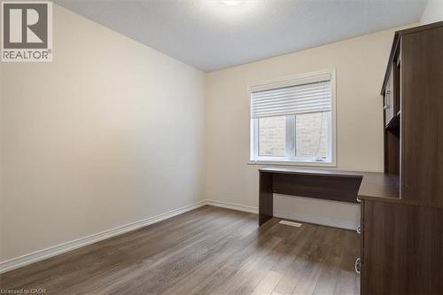 Unfurnished room with dark wood-style flooring, visible vents, a textured ceiling, and baseboards - 13 Steven Drive, Thorold, ON - Indoor Photo Showing Other Room