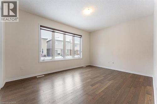 Spare room featuring dark wood-style floors, visible vents, and baseboards - 13 Steven Drive, Thorold, ON - Indoor Photo Showing Other Room