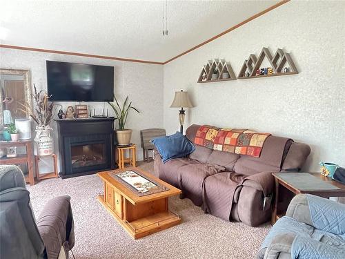 195 4Th Avenue, Rivers, MB - Indoor Photo Showing Living Room With Fireplace