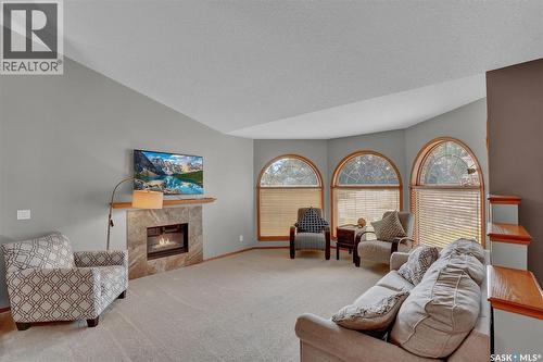 3210 Peyson Bay E, Regina, SK - Indoor Photo Showing Living Room With Fireplace