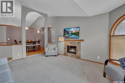 3210 Peyson Bay E, Regina, SK - Indoor Photo Showing Other Room With Fireplace
