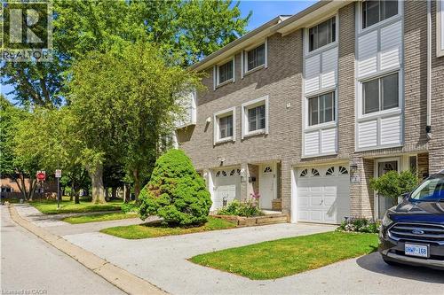Brick exterior with white window trim and white decorative siding panels - 145 Rice Avenue Unit# 2, Hamilton, ON - Outdoor With Facade