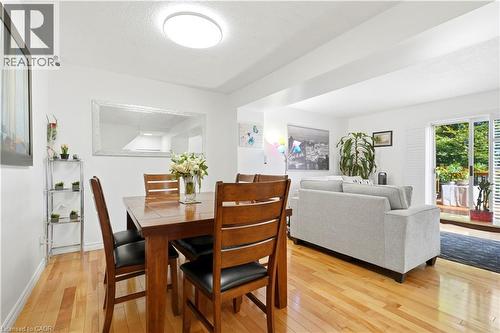 Hardwood flooring throughout, featuring a bright recessed ceiling light and a sliding glass door leading to an outdoor deck - 145 Rice Avenue Unit# 2, Hamilton, ON - Indoor
