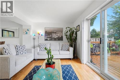 Hardwood-finish flooring, sliding glass door, white walls, recessed lighting, and a wood deck - 145 Rice Avenue Unit# 2, Hamilton, ON - Indoor Photo Showing Living Room