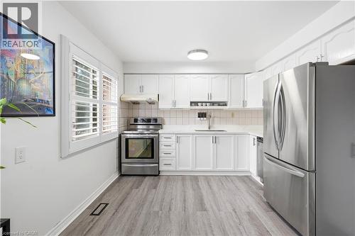 White cabinetry with brushed nickel hardware - 145 Rice Avenue Unit# 2, Hamilton, ON - Indoor Photo Showing Kitchen