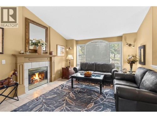 Display storage between living room and dining room. - 4000 Gallaghers Terrace, Kelowna, BC - Indoor Photo Showing Living Room With Fireplace