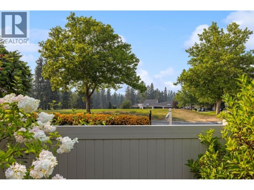 View over fence looking at Clubhouse. - 4000 Gallaghers Terrace, Kelowna, BC - Outdoor