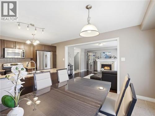 Open-concept dining area with tile flooring and a contemporary pendant light - 98 Willow Lane, Grimsby, ON - Indoor