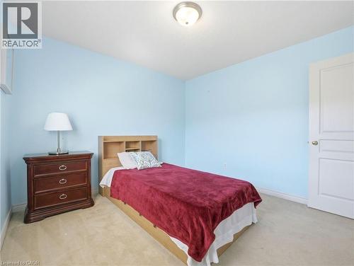 Light-colored wall-to-wall carpeting complements the light blue wall finish - 98 Willow Lane, Grimsby, ON - Indoor Photo Showing Bedroom