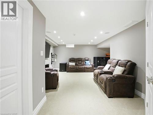 Open-concept room featuring light-colored carpeting, recessed lighting, and a white ceiling - 98 Willow Lane, Grimsby, ON - Indoor