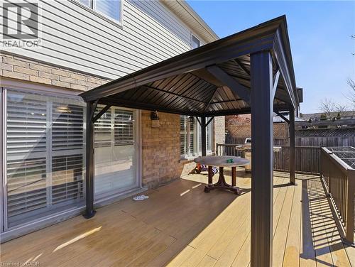 Expansive wood-finish deck featuring a built-in gazebo with a dark metal frame and pitched roof - 98 Willow Lane, Grimsby, ON - Outdoor