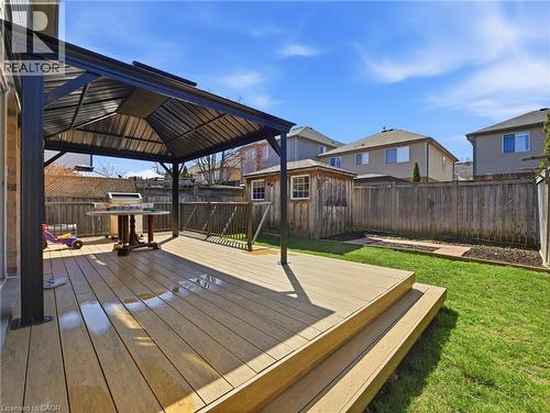 Spacious rear yard featuring a multi-level wood-finish deck with a black metal gazebo - 98 Willow Lane, Grimsby, ON - Outdoor With Deck Patio Veranda