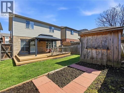 Rear exterior featuring a multi-level wood-finish deck with a metal gazebo, brick facade, and horizontal siding - 98 Willow Lane, Grimsby, ON - Outdoor With Deck Patio Veranda