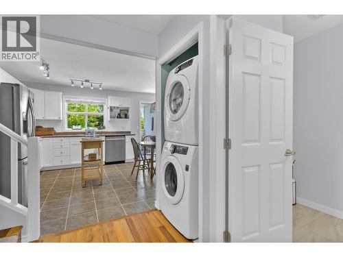 Hallway from Living area to kitchen - 3825 Glen Canyon Drive Unit# 104, West Kelowna, BC - Indoor Photo Showing Laundry Room