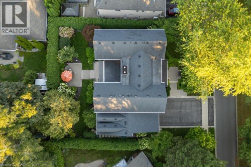 Multiple structures with dark shingle roofing, paved driveways, and manicured landscaping - 253 Rossmore Boulevard, Burlington, ON - Outdoor