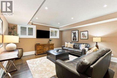 Recessed lighting illuminates wood-finish flooring - 253 Rossmore Boulevard, Burlington, ON - Indoor Photo Showing Living Room