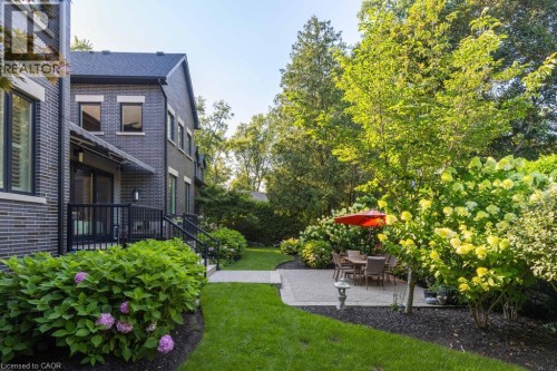 Manicured lawn, mature trees, and landscaping create a private exterior - 253 Rossmore Boulevard, Burlington, ON - Outdoor