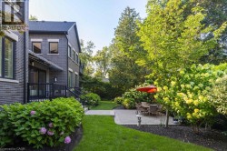 Manicured lawn, mature trees, and landscaping create a private exterior - 